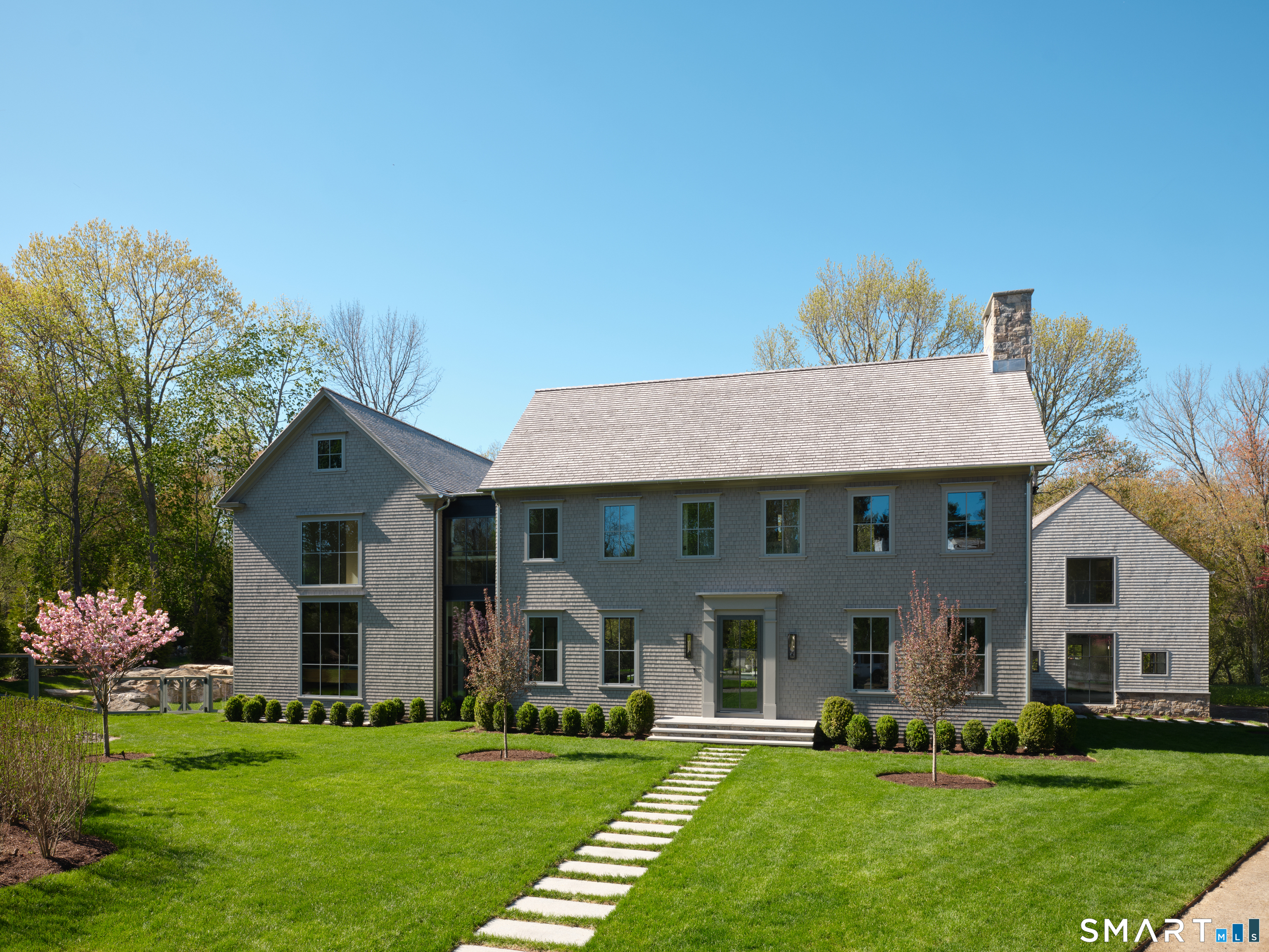 45 Old Farm Road Darien, CT 06820 - Photo 1 of 38 a front view of a house with a garden and trees