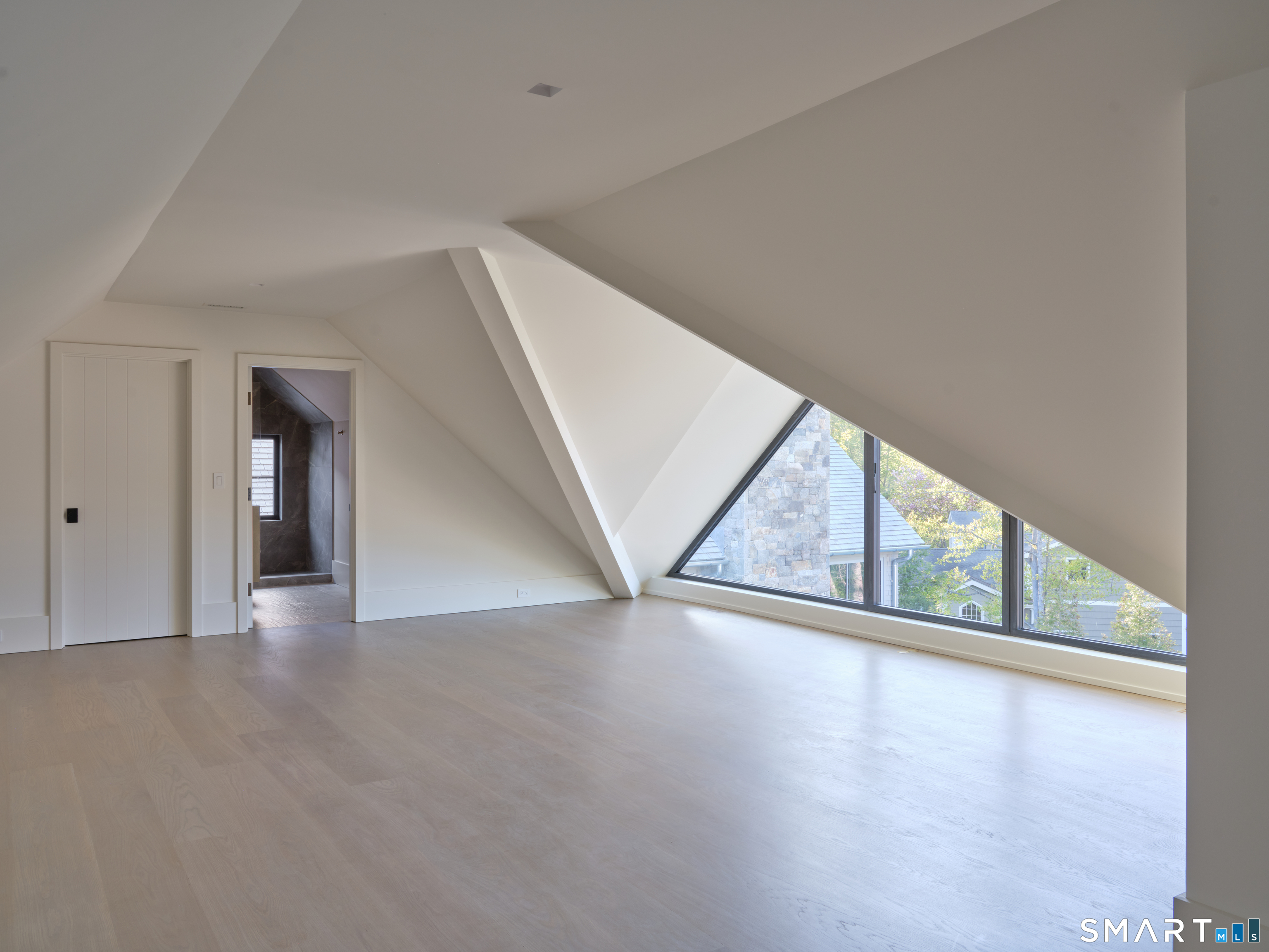 45 Old Farm Road Darien, CT 06820 - Photo 33 of 38 a view of an empty room with wooden floor and windows