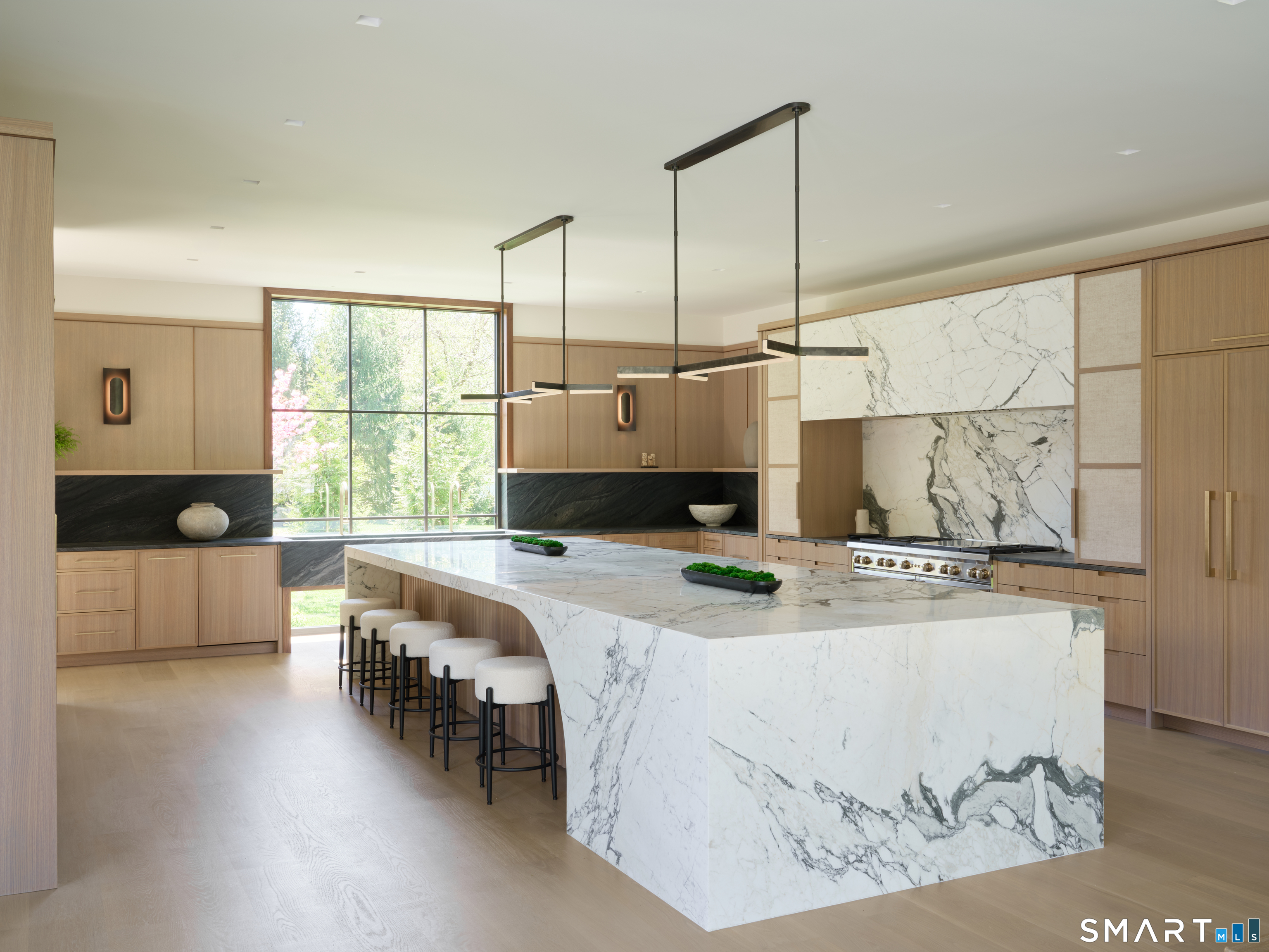 45 Old Farm Road Darien, CT 06820 - Photo 4 of 38 a kitchen with a stove a sink a counter top space and living room view