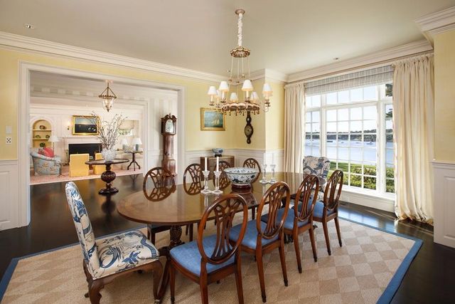 a view of a dining room with furniture and a chandelier