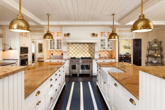 a kitchen with stainless steel appliances kitchen island granite countertop counter space a sink and a wooden floors