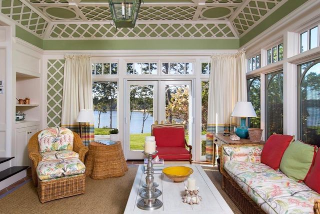 a living room with furniture and floor to ceiling windows