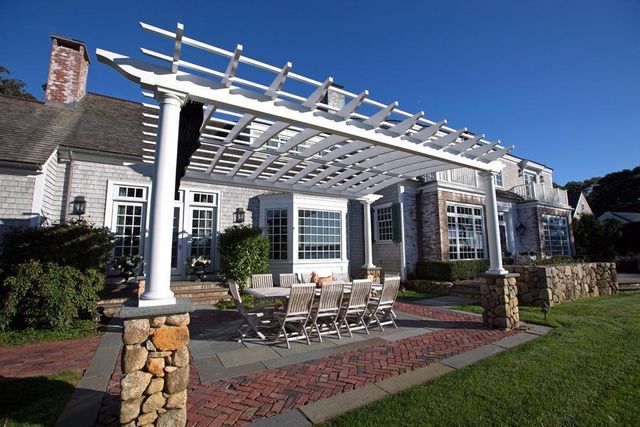 a view of a house with patio and a garden