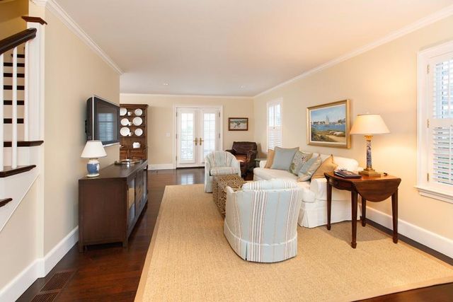 a living room with furniture a lamp and a potted plant
