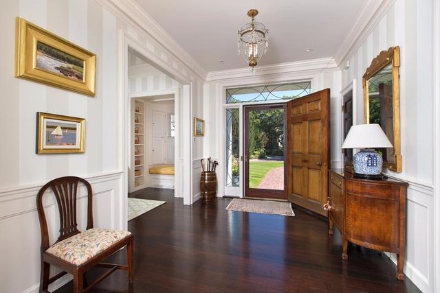 a view of a livingroom with furniture wooden floor a chandelier
