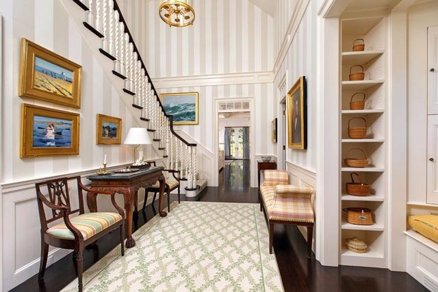 a living room with furniture a rug and a window