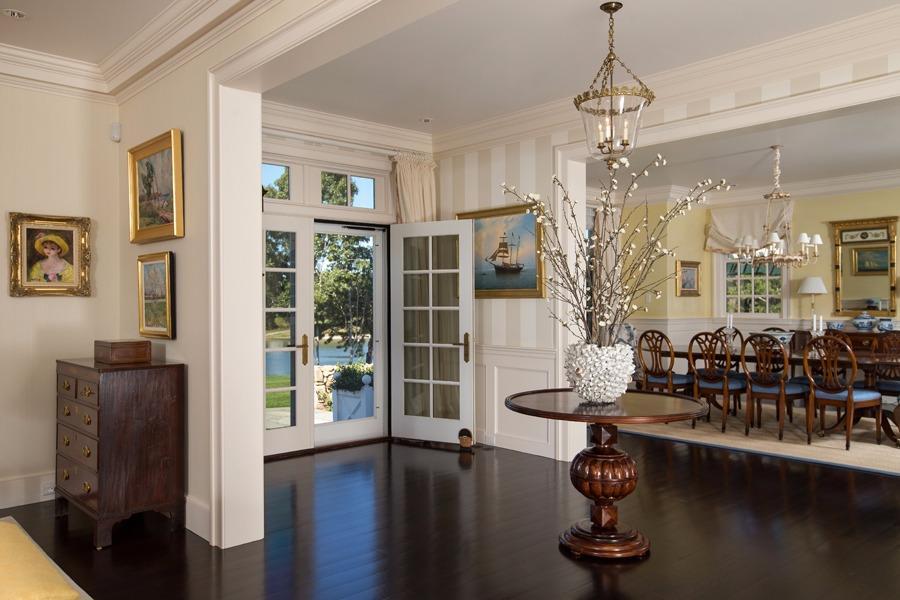 260 North Bay Road Osterville, MA 02655 - Photo 10 of 35 a room with lots of wooden furniture and floor to ceiling windows