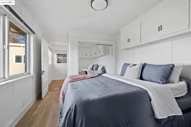 a bed sitting in a bedroom next to a window