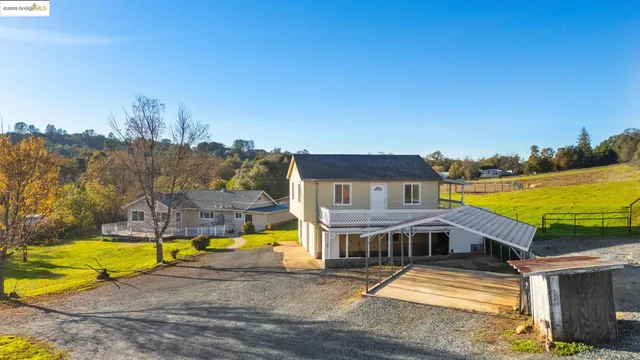 a view of a house with swimming pool and ocean view