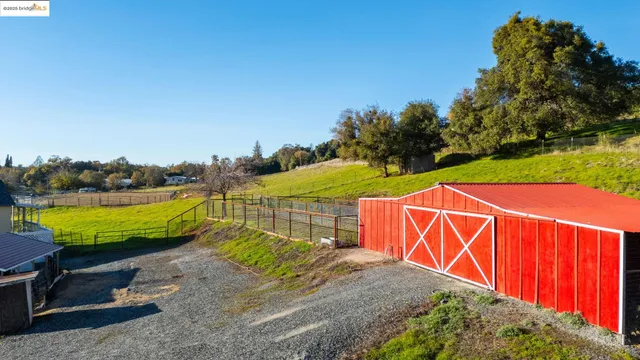a view of a swimming pool with a patio and a yard