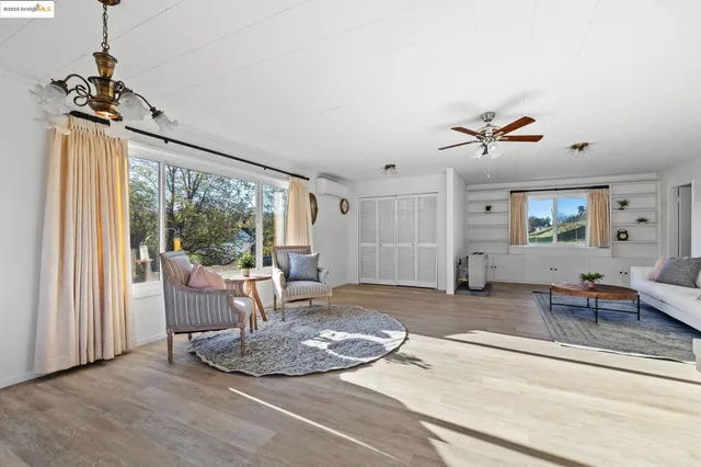 a view of a livingroom with furniture wooden floor and a chandelier
