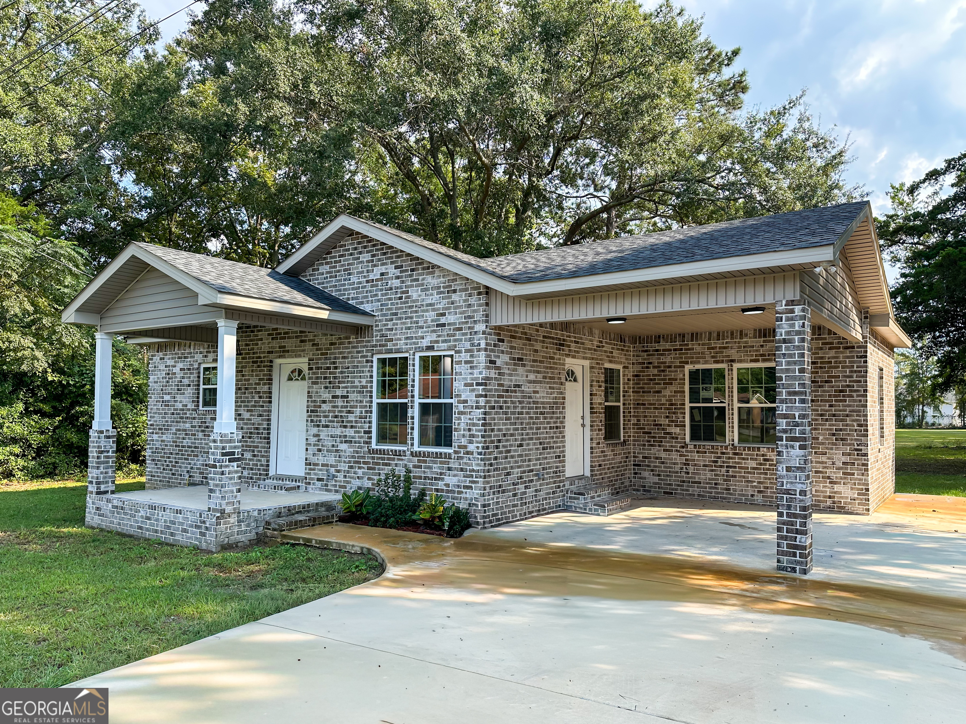 a front view of a house with garden