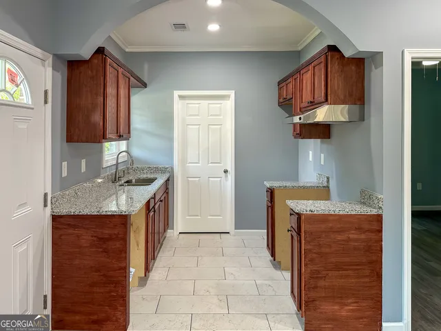a kitchen with stainless steel appliances granite countertop a stove and a refrigerator