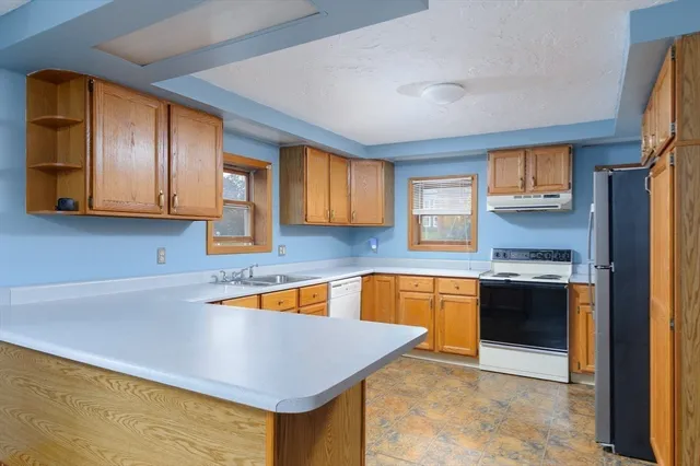 a kitchen with stainless steel appliances granite countertop a sink and cabinets