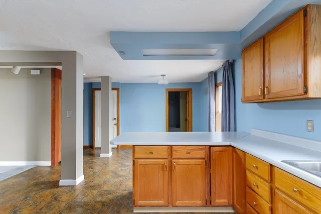 a view of a kitchen with granite countertop cabinets