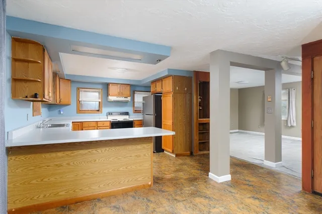 a kitchen with stainless steel appliances granite countertop a refrigerator and a stove
