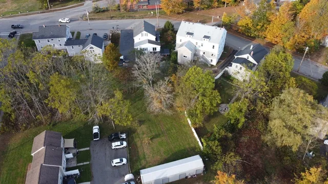 an aerial view of a house with garden space and street view