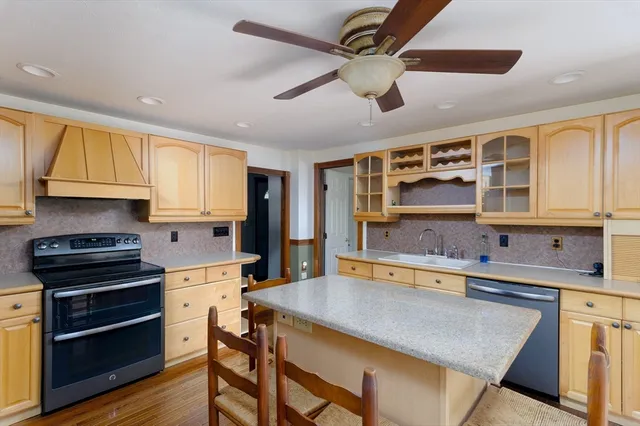 a kitchen with stainless steel appliances granite countertop a stove and cabinets