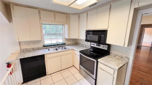 a kitchen with a sink stove and microwave