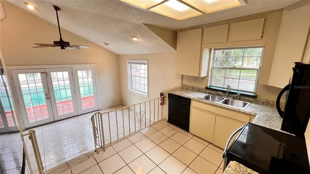 a view of a kitchen with a sink and a window