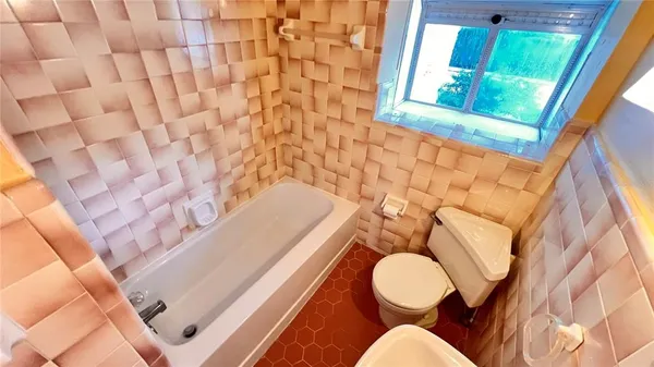 a bathroom with a toilet and a mirror