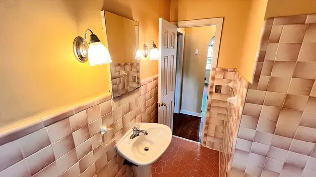 a bathroom with a sink and shower curtain