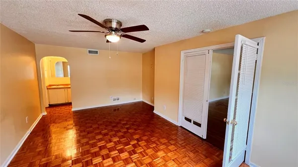 a view of a hallway with wooden floor