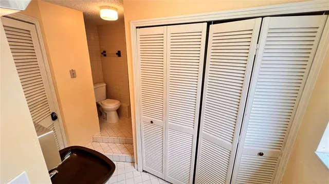 a white toilet sitting next to a bathroom sink