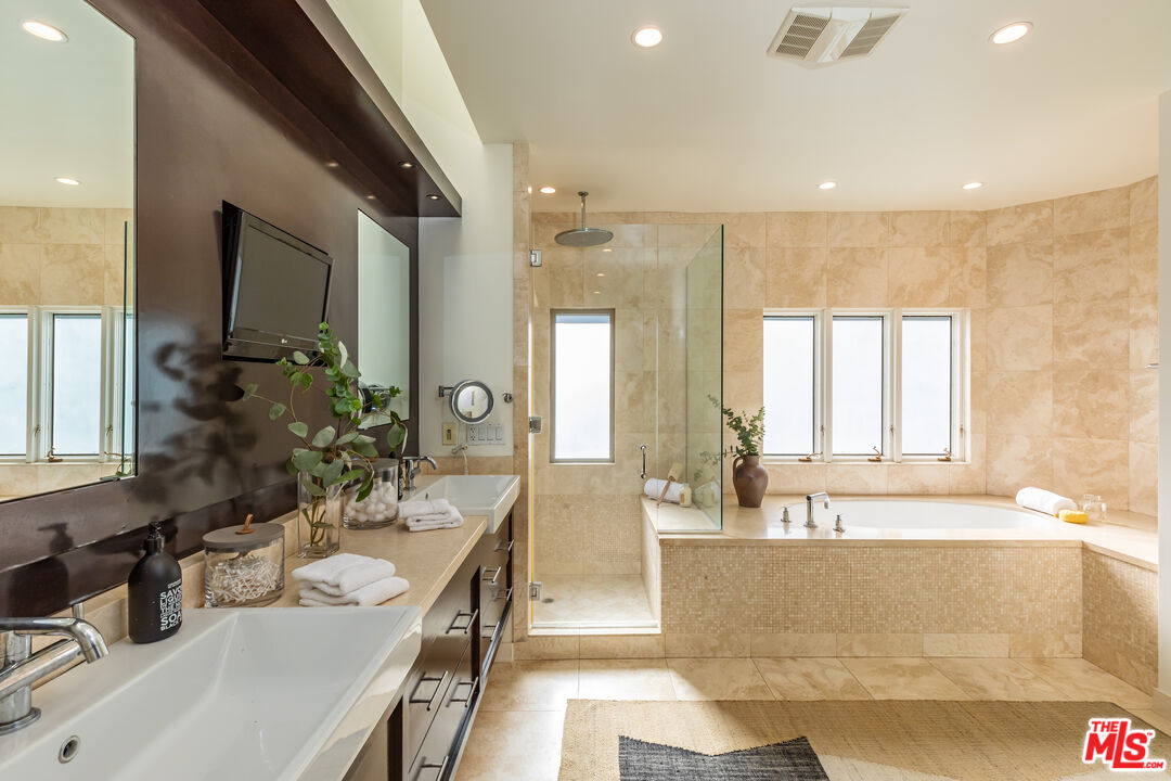 851 Glenmont Avenue Los Angeles, CA 90024 - Photo 15 of 26 a large bathroom with a large tub a sink a window and a shower