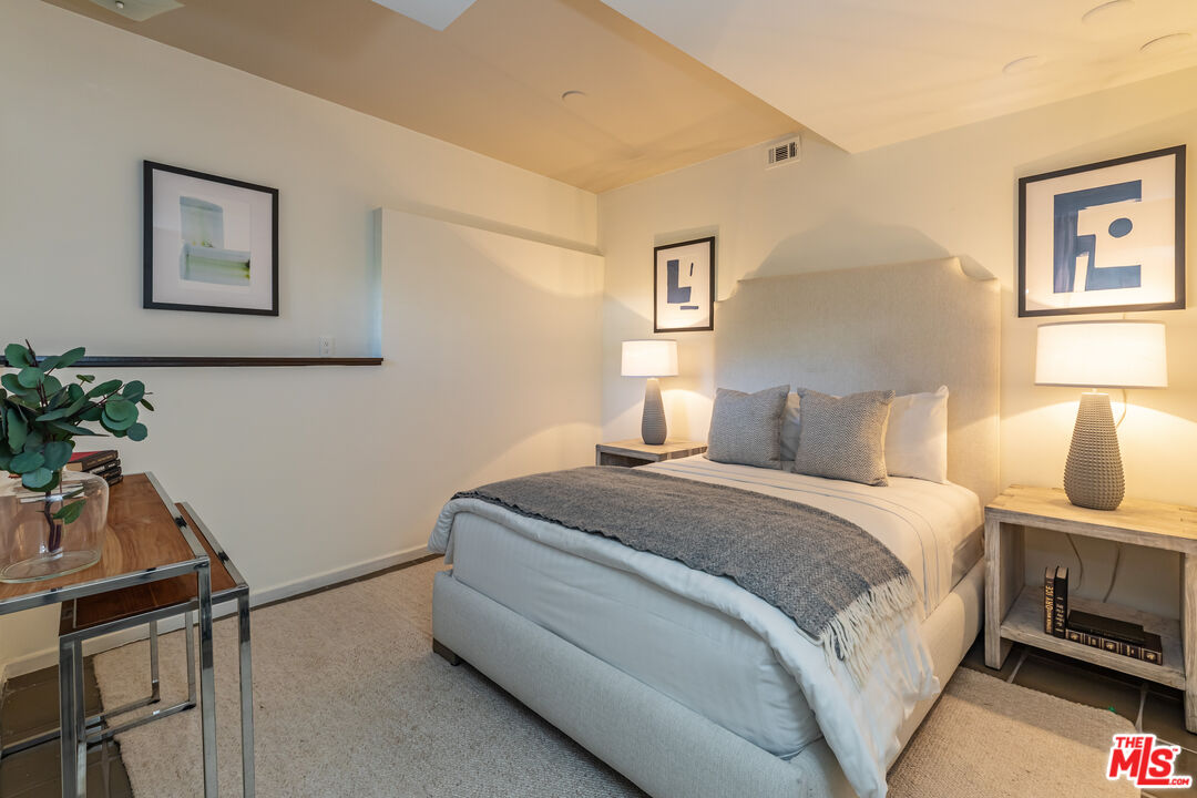 851 Glenmont Avenue Los Angeles, CA 90024 - Photo 21 of 26 a bedroom with a bed and a potted plant