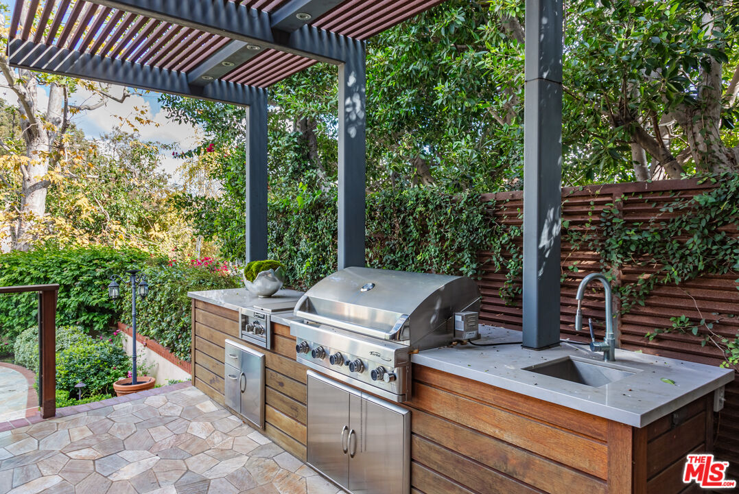 851 Glenmont Avenue Los Angeles, CA 90024 - Photo 22 of 26 a view of a backyard with barbeque grill and outdoor seating