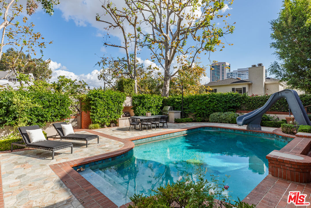 851 Glenmont Avenue Los Angeles, CA 90024 - Photo 25 of 26 a view of swimming pool with lawn chairs and plants