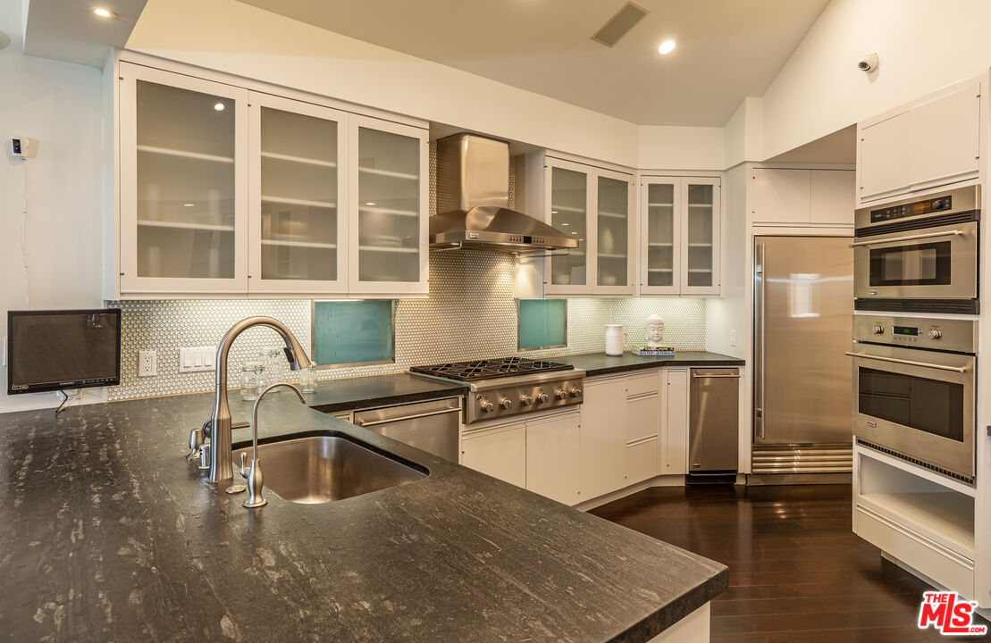 851 Glenmont Avenue Los Angeles, CA 90024 - Photo 9 of 26 a kitchen with a stove a sink and a microwave