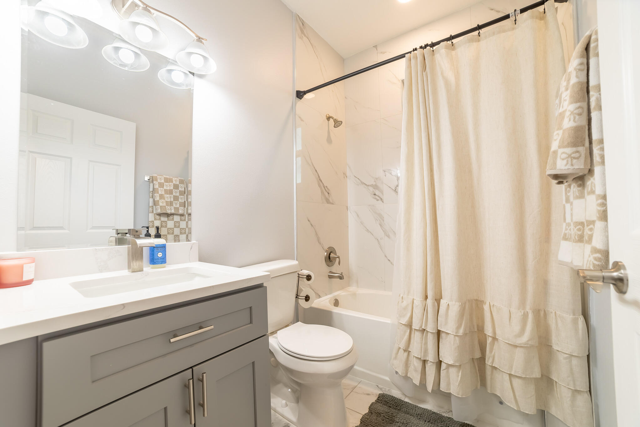 8640 Southwest 7th Lane Okeechobee, FL 34974 - Photo 19 of 52 a bathroom with a sink a toilet and shower curtain