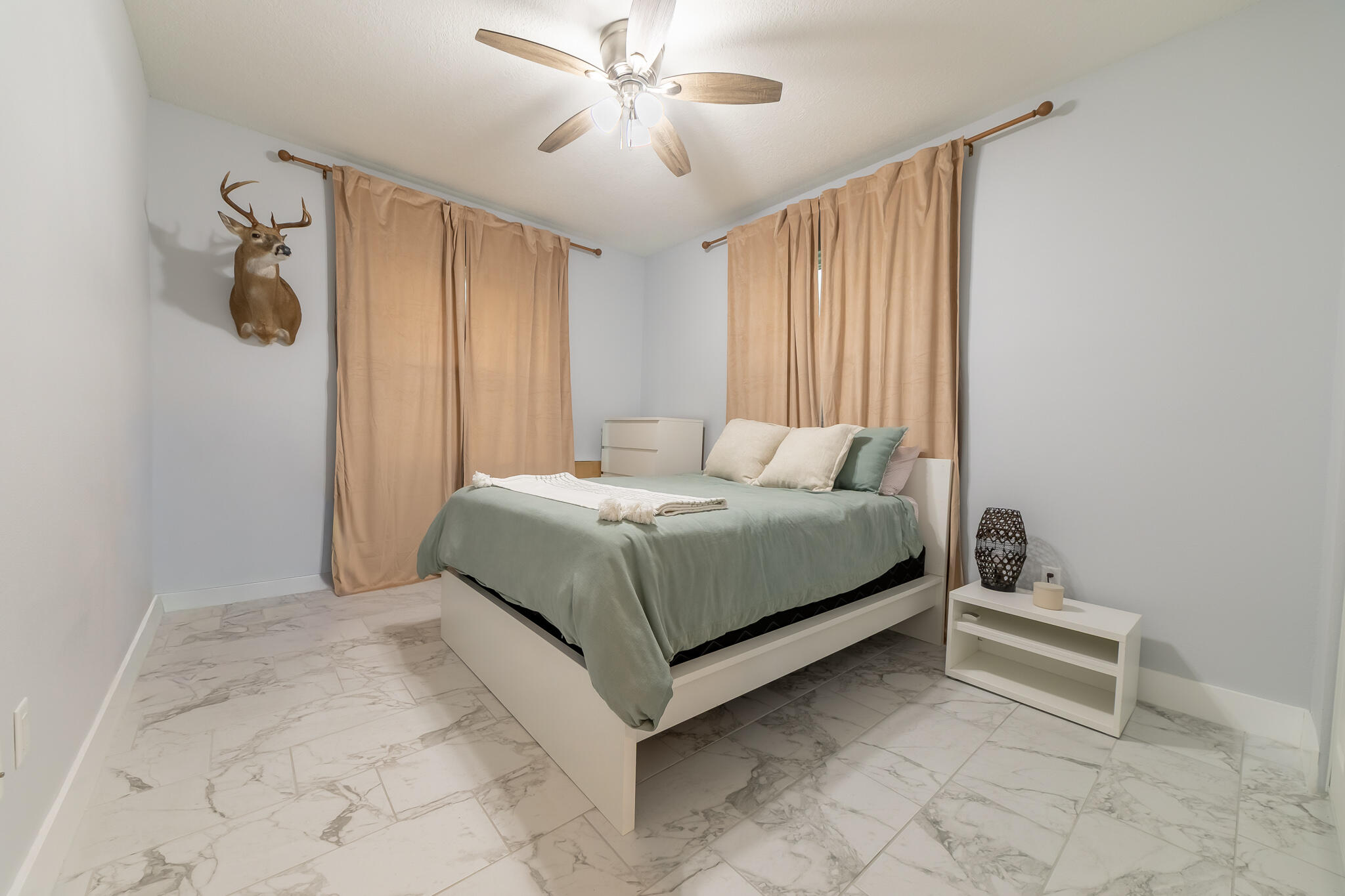 8640 Southwest 7th Lane Okeechobee, FL 34974 - Photo 22 of 52 a bedroom with a bed and a chandelier