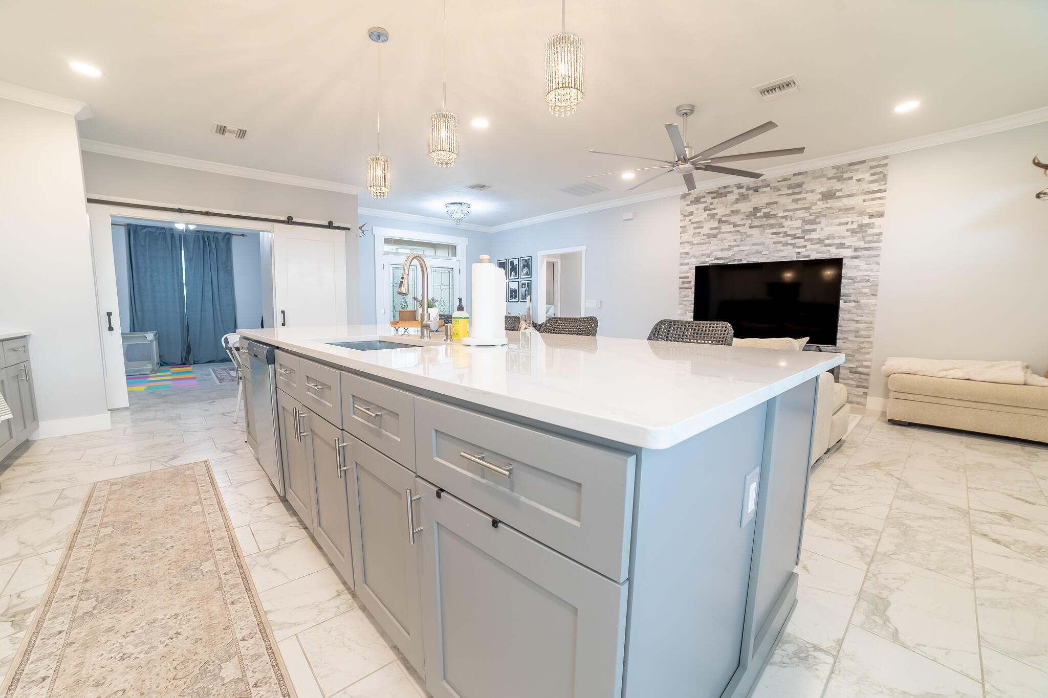 8640 Southwest 7th Lane Okeechobee, FL 34974 - Photo 10 of 52 a kitchen with stainless steel appliances a white stove top oven a sink dishwasher and a refrigerator with wooden floor