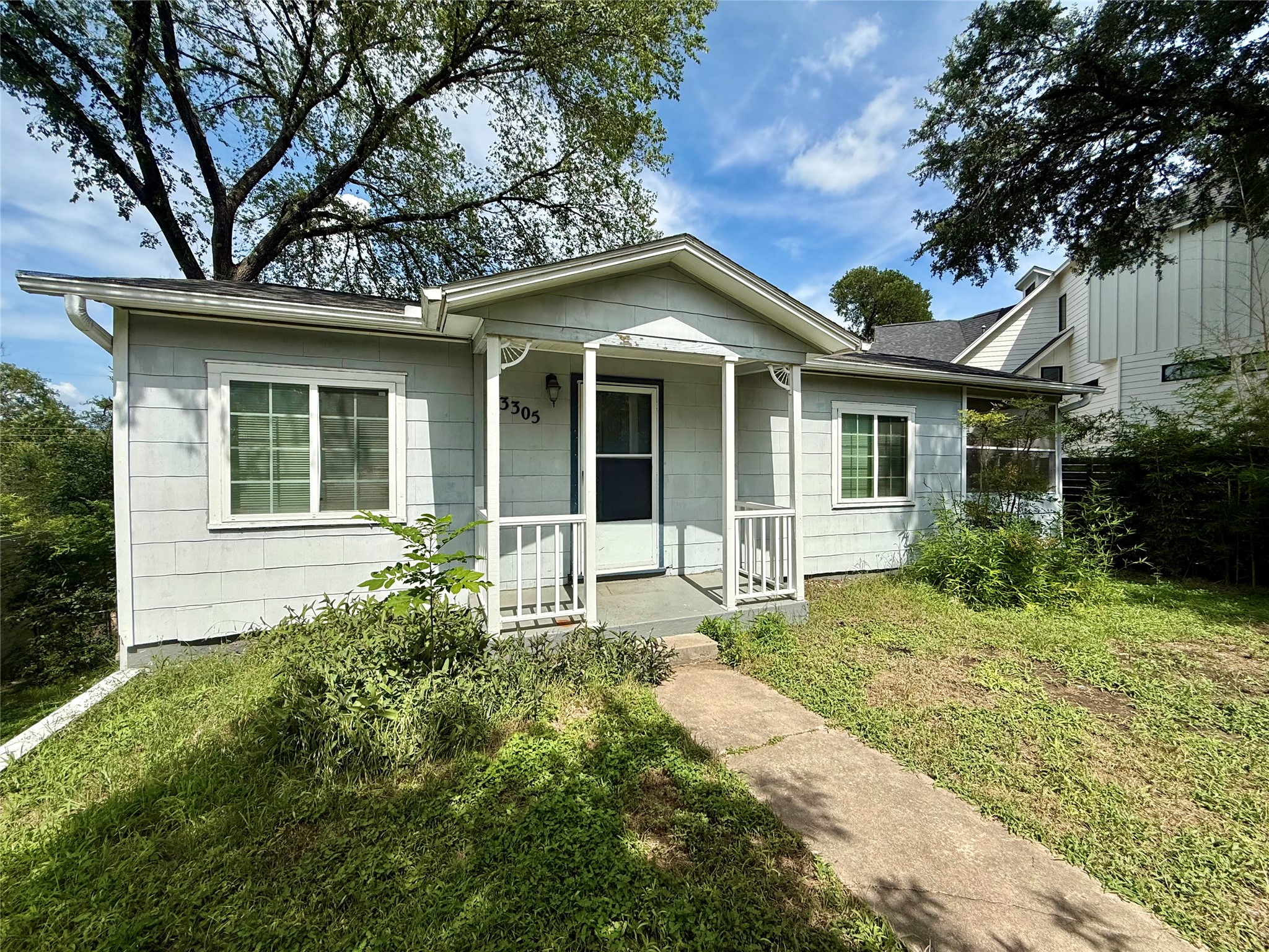 3305 Merrie Lynn Avenue Austin, TX 78722 - Photo 2 of 22 A charming single-level residence nestled amidst established trees and a lush green landscape.
