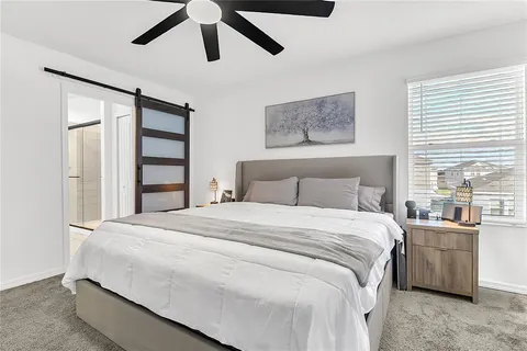 a bedroom with a bed and window