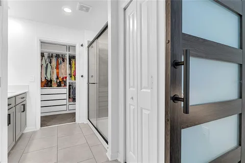 a view of a hallway with entryway and stairs