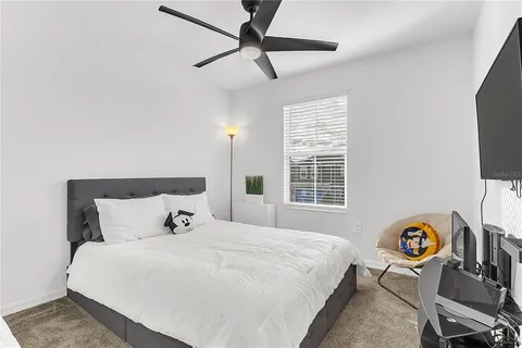 a bedroom with a bed and a tv