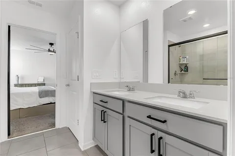 a bathroom with a granite countertop sink mirror and double