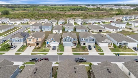 an aerial view of residential houses with outdoor space
