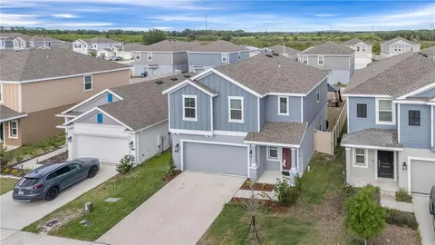 an aerial view of a house with a yard