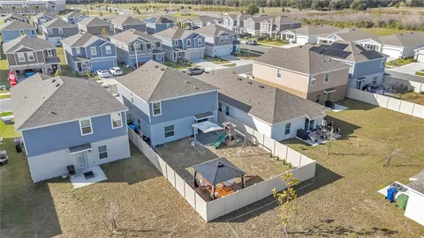an aerial view of a house with a lake view