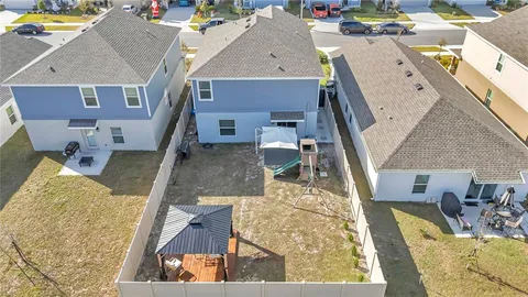 an aerial view of a house with swimming pool