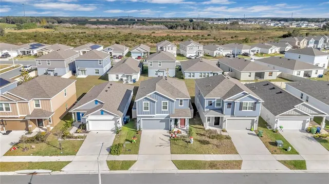 an aerial view of residential houses with outdoor space
