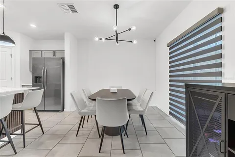 a view of a dining room with furniture and a chandelier