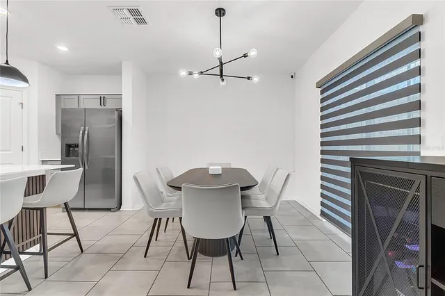 a view of a dining room with furniture and a chandelier
