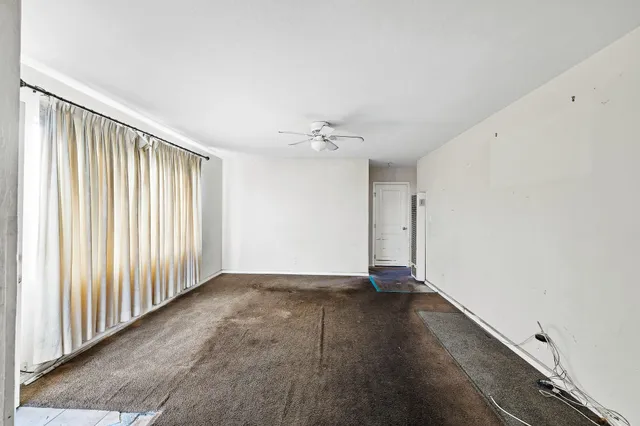 an empty room with wooden floor and a window