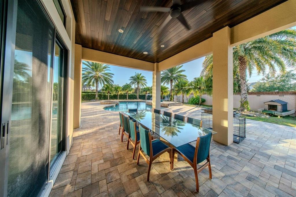 4303 Isabella Circle Windermere, FL 34786 - Photo 40 of 77 a dining room with furniture and a floor to ceiling window